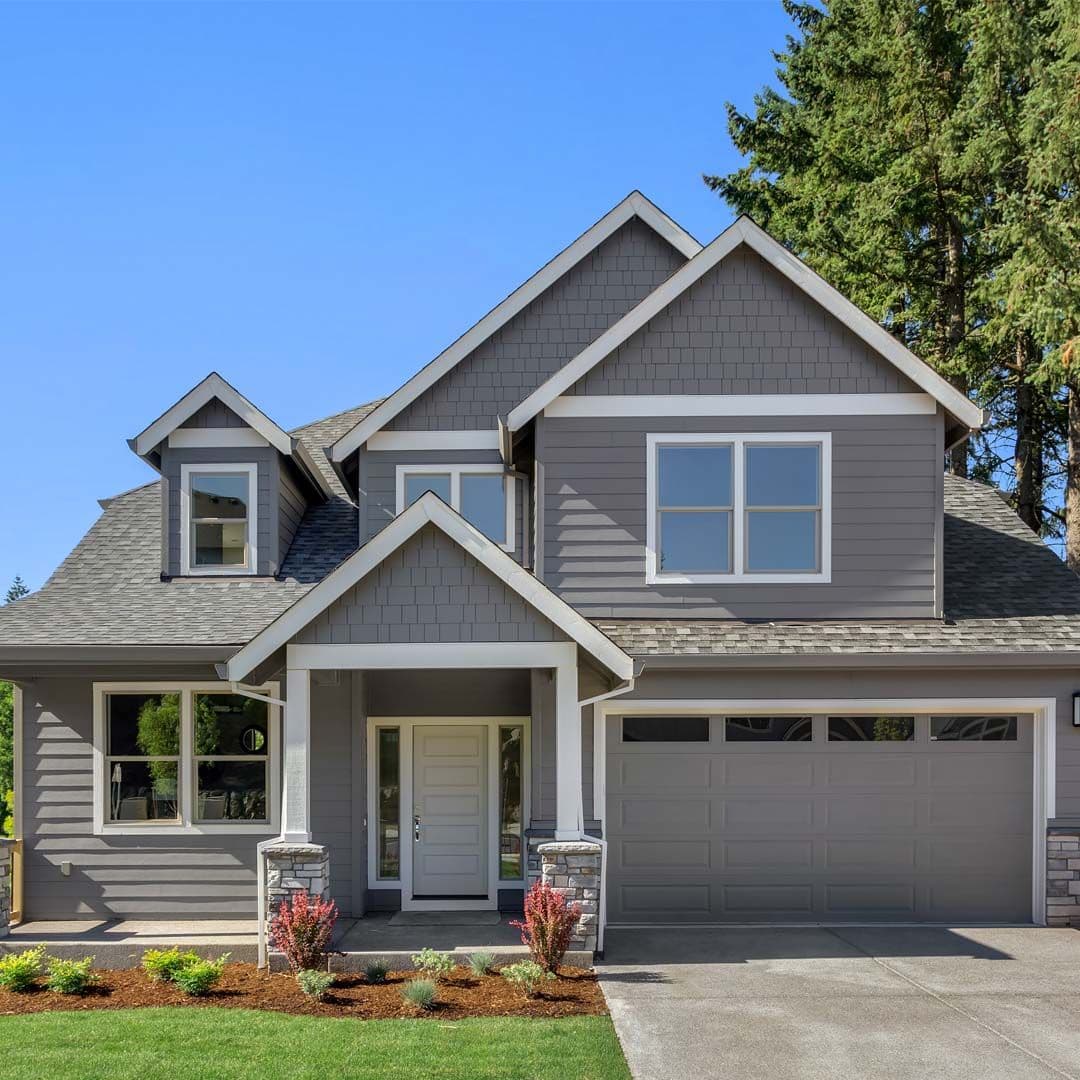 A house with new gray siding and white trim.
