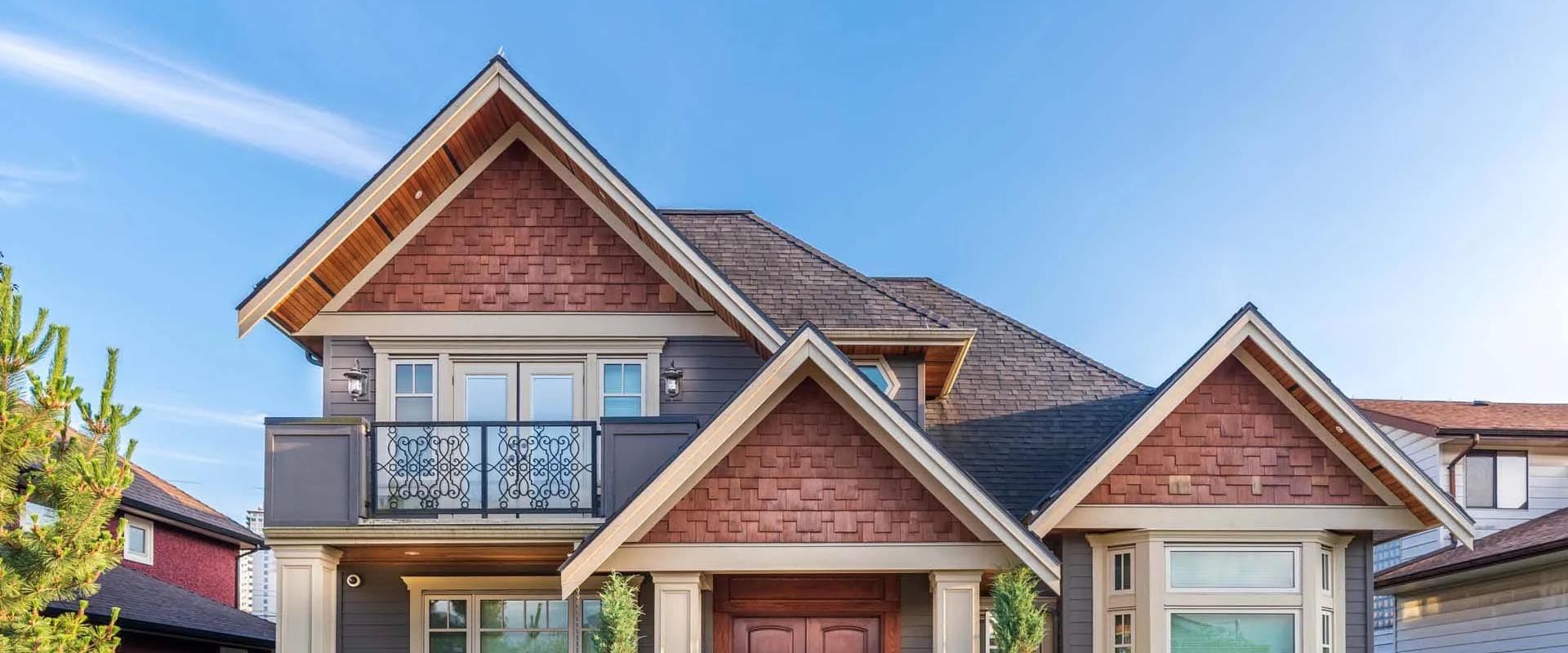 A house with mixed gray and brown shingle siding.