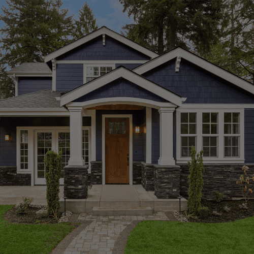 A house with white trim and blue shingle siding.